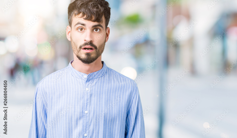 Young handsome business man over isolated background afraid and shocked with surprise expression, fear and excited face. Young handsome business man over isolated background afraid and shocked with surprise expression, fear and excited face.