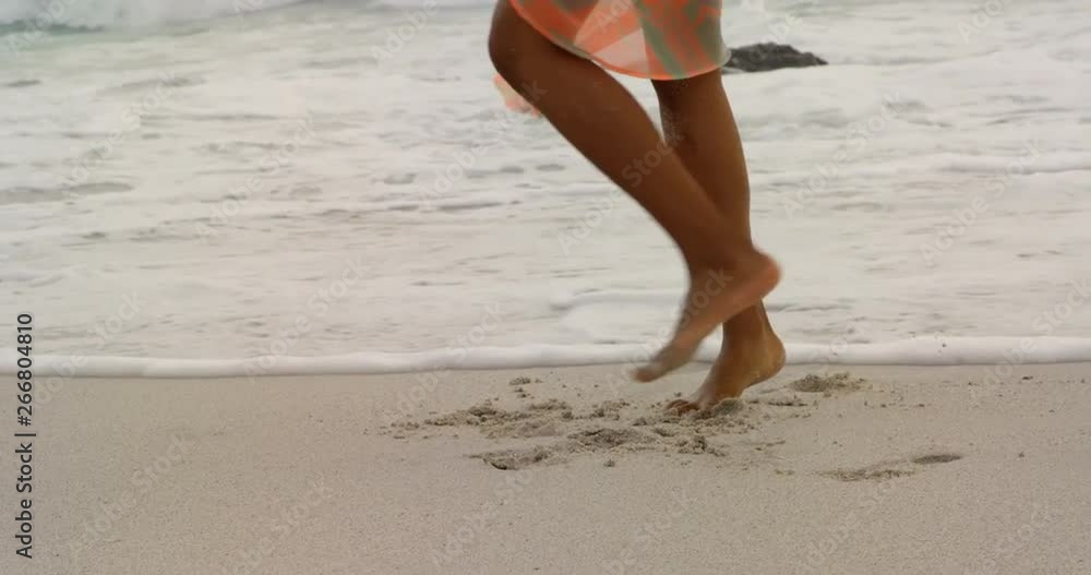 Low section of mixed race woman walking on the beach 4k Low section of mixed race woman walking on the beach 4k