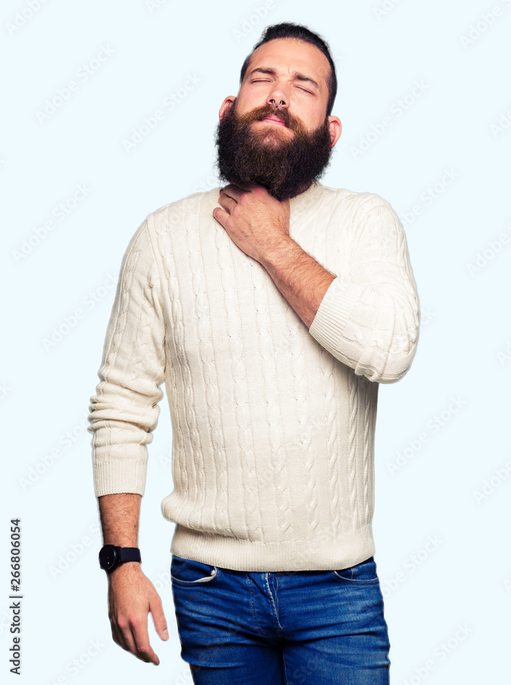 Young hipster man wearing winter sweater Touching painful neck, sore throat for flu, clod and infection Young hipster man wearing winter sweater Touching painful neck, sore throat for flu, clod and infection