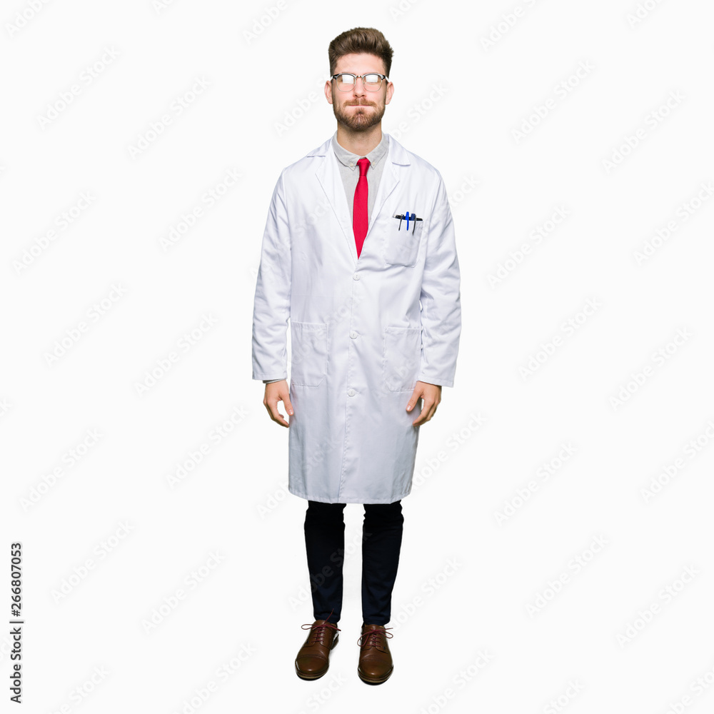 Young handsome scientist man wearing glasses puffing cheeks with funny face. Mouth inflated with air, crazy expression. Young handsome scientist man wearing glasses puffing cheeks with funny face. Mouth inflated with air, crazy expression.