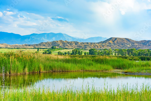 Fototapeta Naklejka Na Ścianę i Meble -  Lake with mountains in the background. Rest in Kyrgyzstan. Nature in the area of lake Issyk Kul.
