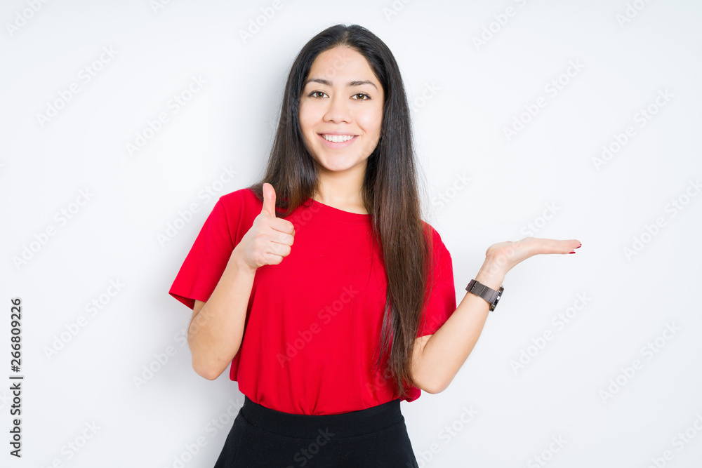 Beautiful brunette woman wearing red t-shirt over isolated background Showing palm hand and doing ok gesture with thumbs up, smiling happy and cheerful Beautiful brunette woman wearing red t-shirt over isolated background Showing palm hand and doing ok gesture with thumbs up, smiling happy and cheerful