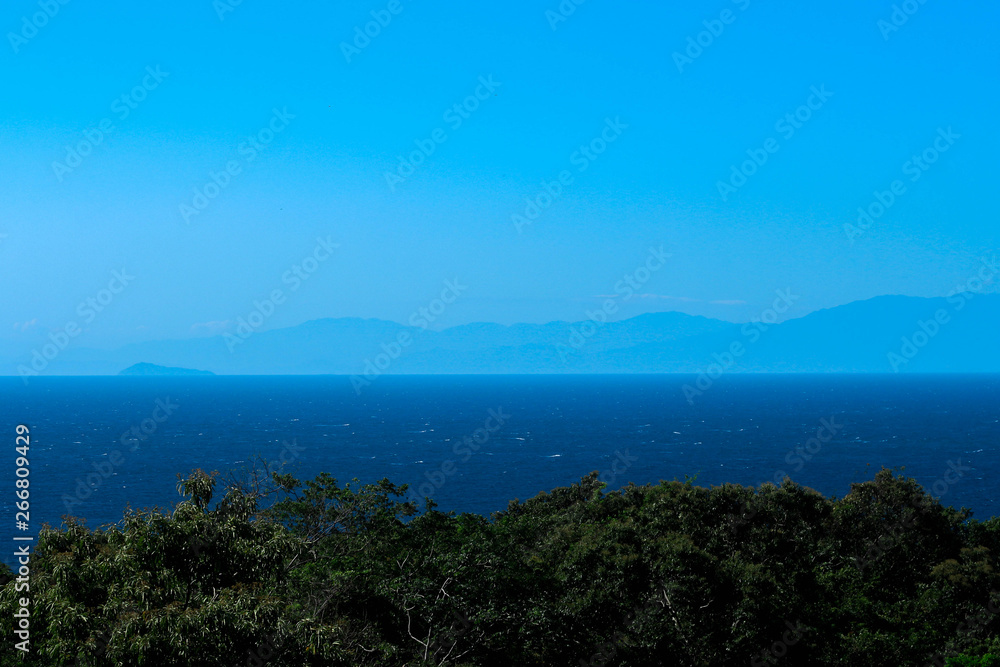Blue landscape with mountains and sea