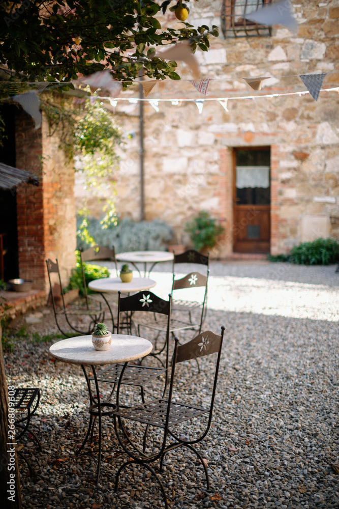 old tables in courtyard of tuscan villa