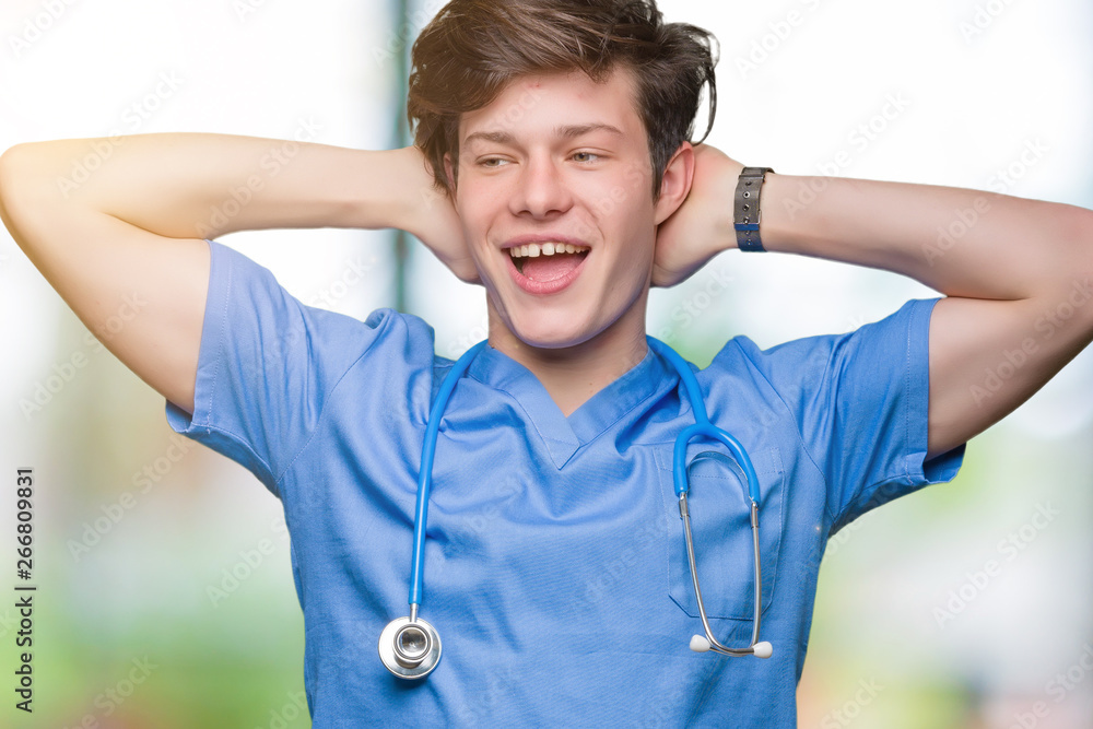 Young doctor wearing medical uniform over isolated background Relaxing and stretching with arms and hands behind head and neck, smiling happy Young doctor wearing medical uniform over isolated background Relaxing and stretching with arms and hands behind head and neck, smiling happy