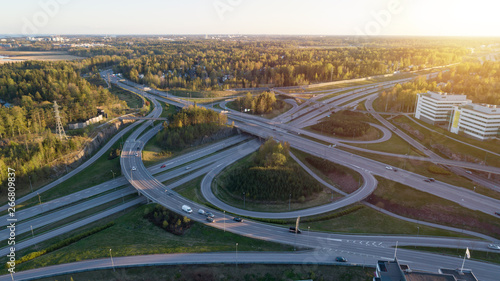 Aerial view of a big highway intersection in Finland, Helsinki, at sunset. Transportation and communications concept.