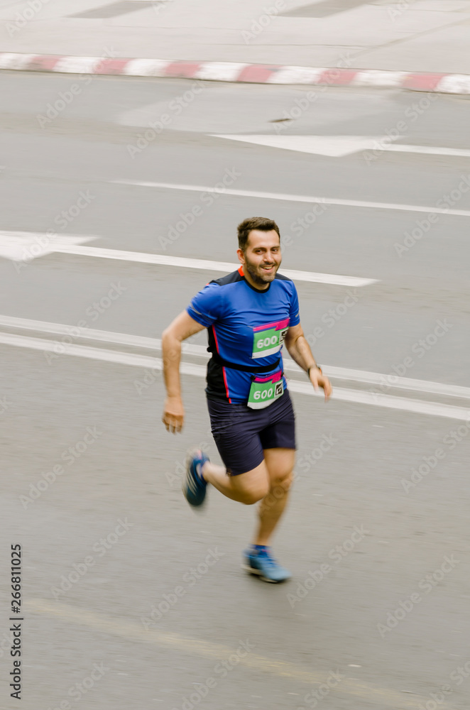 Fototapeta premium Man smiling and running fast like flash, motion blurred