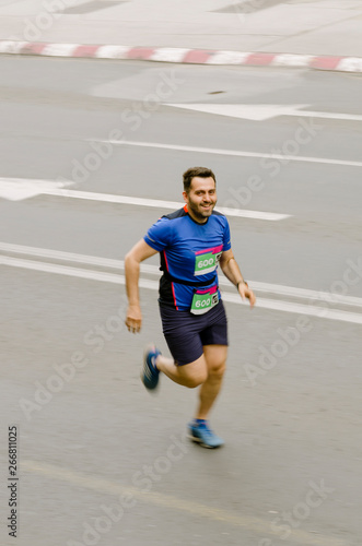 Man smiling and running fast like flash, motion blurred