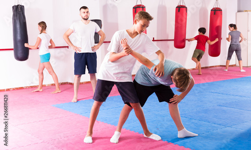 Kids practicing in pair self-protection