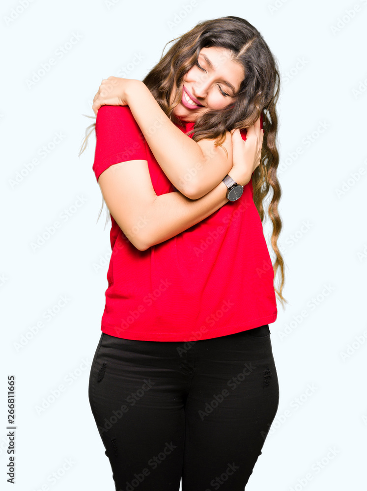 Young beautiful woman wearing casual t-shirt Hugging oneself happy and positive, smiling confident. Self love and self care Young beautiful woman wearing casual t-shirt Hugging oneself happy and positive, smiling confident. Self love and self care