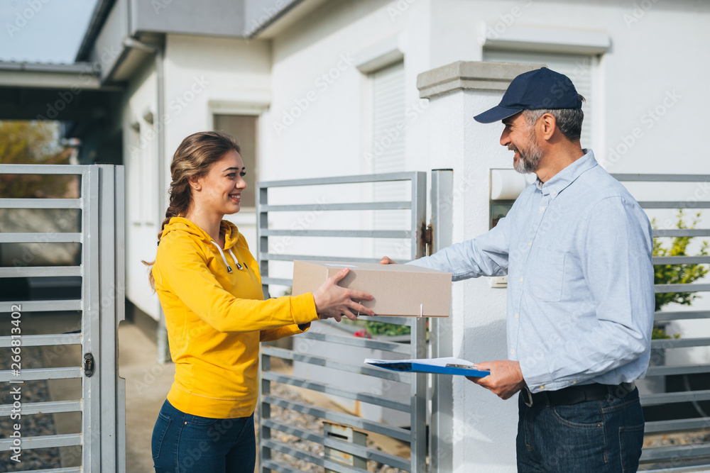 woman sending package over post express service woman sending package over post express service