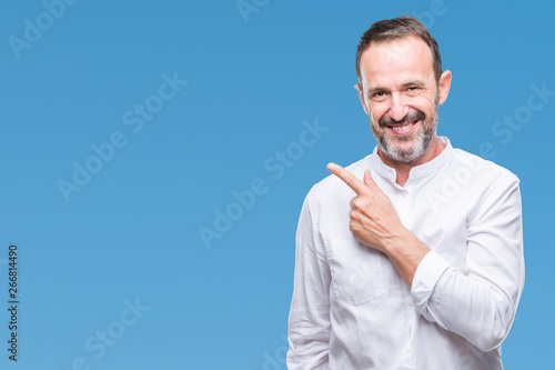 Middle age hoary senior man over isolated background cheerful with a smile of face pointing with hand and finger up to the side with happy and natural expression on face looking at the camera.