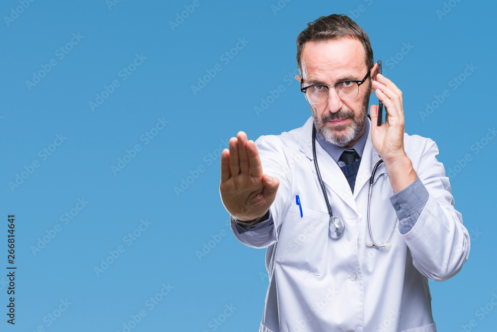 Fototapeta premium Middle age senior hoary doctor man talking on smartphone over isolated background with open hand doing stop sign with serious and confident expression, defense gesture