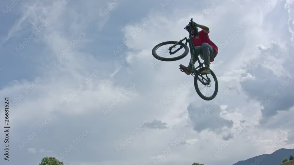 A bike rider flowing through jumps in slow motion A bike rider flowing through jumps in slow motion