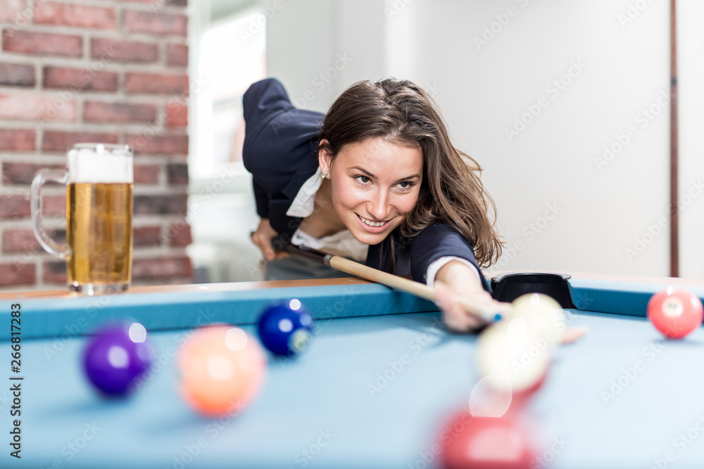 Fototapeta premium Fashionable modern woman playing pool table billiards game.