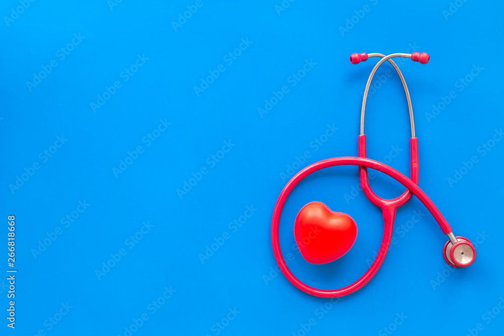 diagnostic and cure of cardiac disease with stethoscope and heart on blue background top view mock-up diagnostic and cure of cardiac disease with stethoscope and heart on blue background top view mock-up