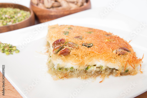 traditional turkish künefe dessert slice on plate