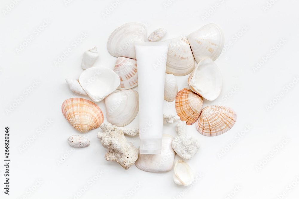 cosmetics with Dead Sea minerals and shells on white table background top view