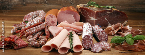 cold meat assortment with delicious salami and fresh herbs . Variety of meat products including coppa and sausages