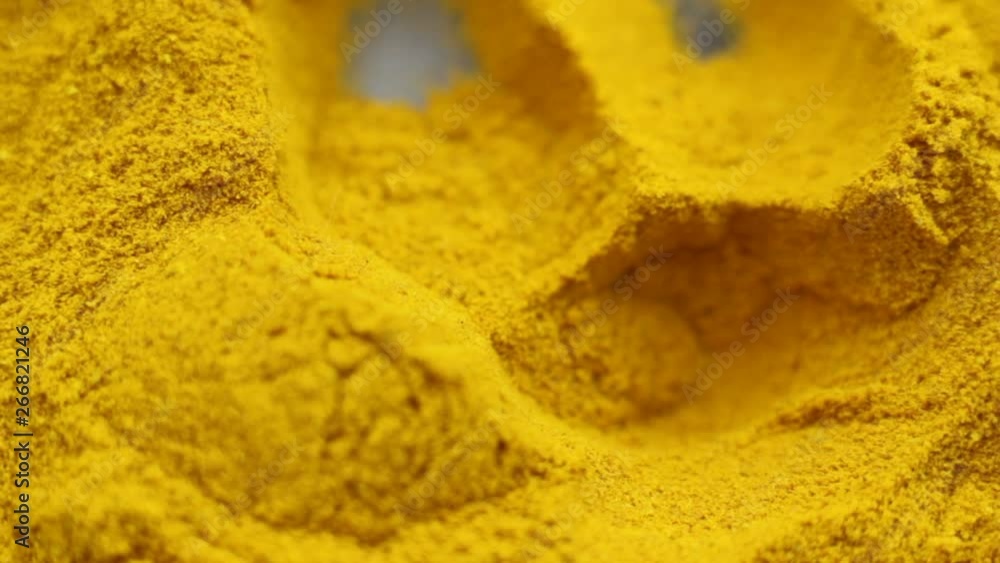 Take a pinch of turmeric powder with hands. Extreme close up Take a pinch of turmeric powder with hands. Extreme close up