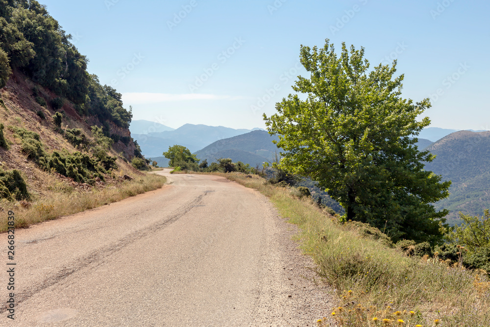 A narrow, rural road in the mountains