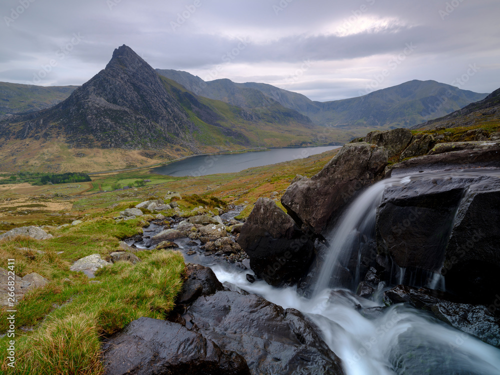 Tryfan in spring with the Afon Lloer in flow over the waterfalls, Wales. Tryfan in spring with the Afon Lloer in flow over the waterfalls, Wales.