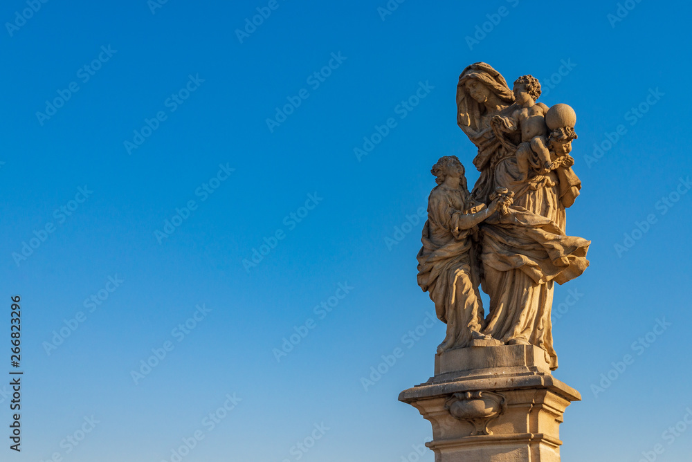 Beautiful delicate and elaborate sandstone religious christian sculpture, Statue of Saint Anne, placed on the balustrade of Charles Bridge, Karlův most, in Prague, Czech Republic.
