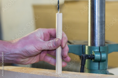 Worker hand holding a wooden detail photo