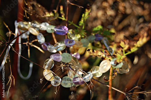 beads of gem stones on the background of dead wood