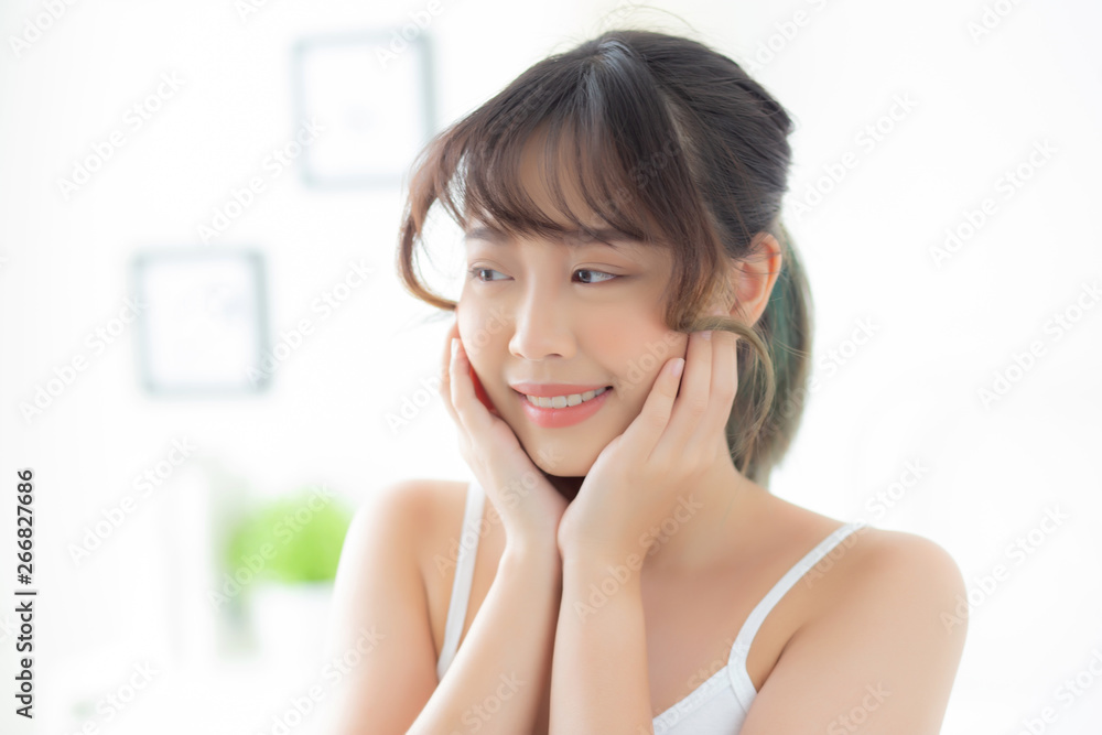 Portrait of beautiful young asian woman smile while wake up healthy and wellness with sunrise at morning in the bedroom, asia girl skin care with happy with fresh, lifestyle and relax concept. Portrait of beautiful young asian woman smile while wake up healthy and wellness with sunrise at morning in the bedroom, asia girl skin care with happy with fresh, lifestyle and relax concept.