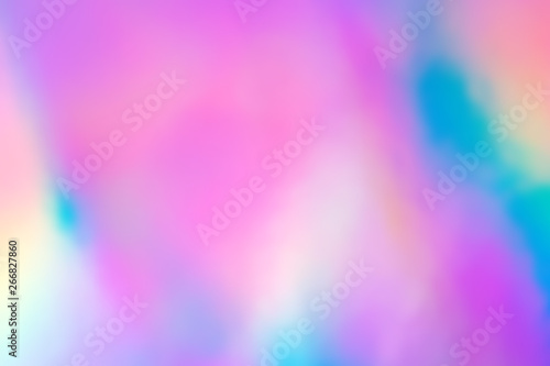 Blurry abstract iridescent holographic foil background.