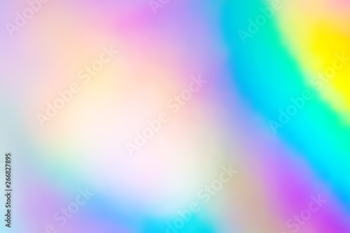 Blurry abstract iridescent holographic foil background.