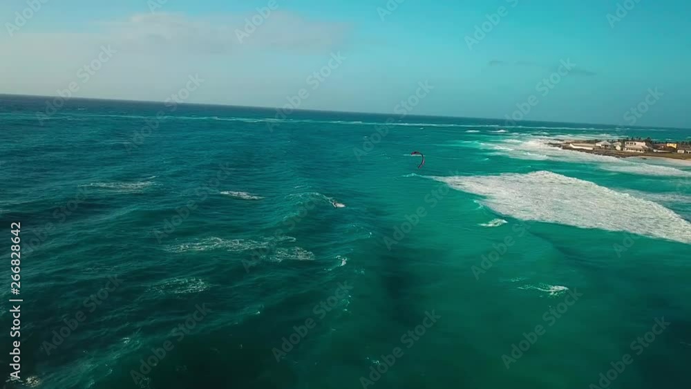Drone following a fast Kite surfer in front of Barbados, surfing stunning blue water in the Carribean. Drone following a fast Kite surfer in front of Barbados, surfing stunning blue water in the Carribean.