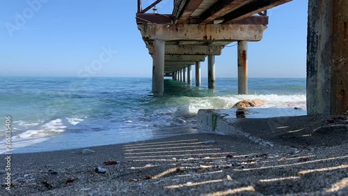 timelapse of summer beach under pier in golden mile marbella,malaga, spain. 
peaceful vacation in the south of spain costa del sol photo