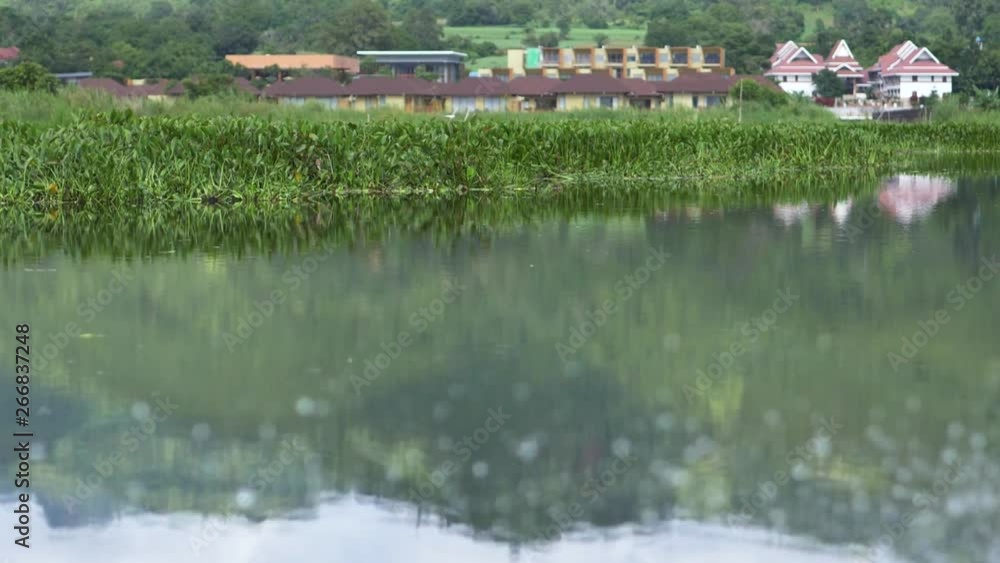 Reflection on Inle Lake, Myanmar, with egret flying in background (slow motion) Reflection on Inle Lake, Myanmar, with egret flying in background (slow motion)