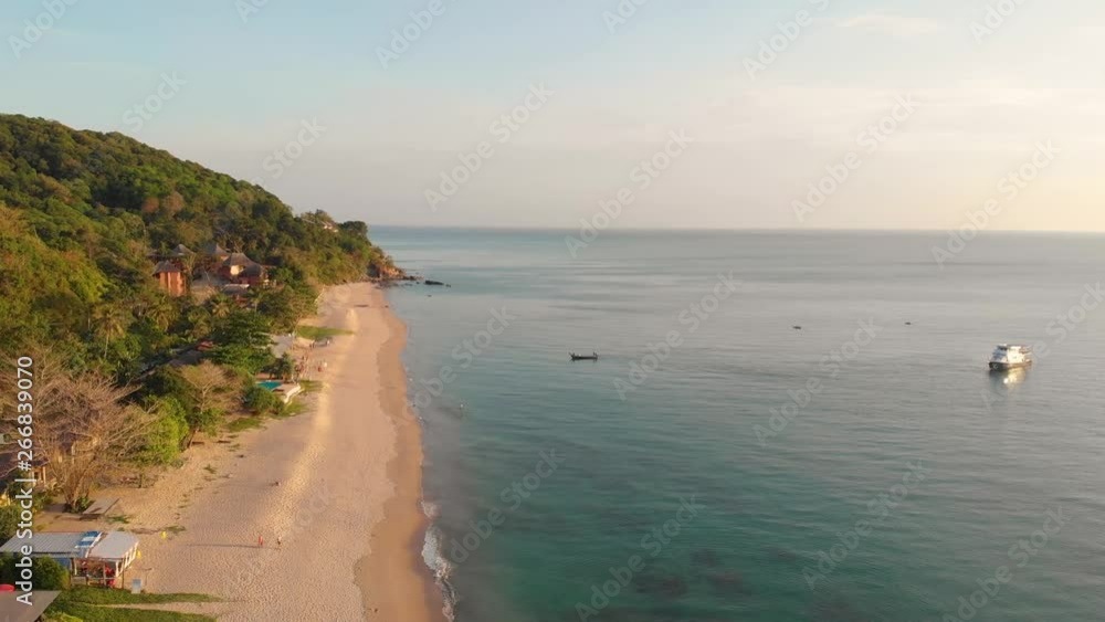 Aerial drone fly above the beach with little boats during sunset in Thailand Aerial drone fly above the beach with little boats during sunset in Thailand