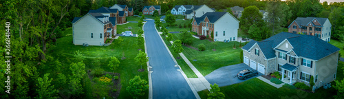 Aerial panorama of modern upper middle class single family homes neighborhood street American real estate in a new construction in Maryland USA	