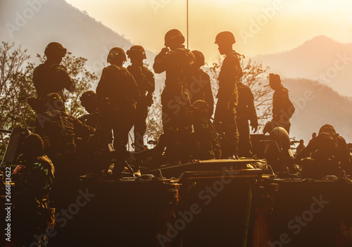 Фотография Backside of  Soldier army operation, Military equipment, army helmet, warpaint, smoked dirty face