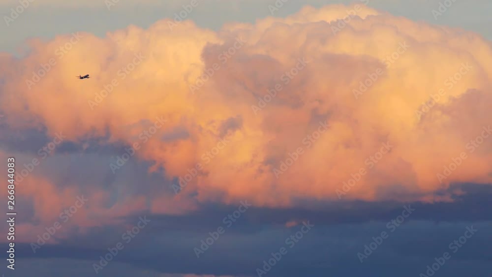 Plane climbs above the storm clouds. Sunset. Plane climbs above the storm clouds. Sunset.
