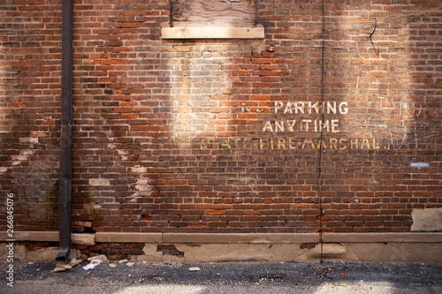 Brick wall "No Parking" paint
