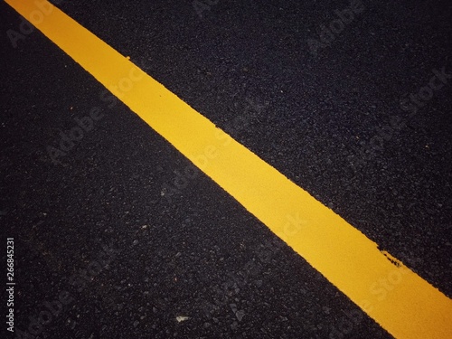 Road traffic paint Yellow on the asphalt surface © suwichan