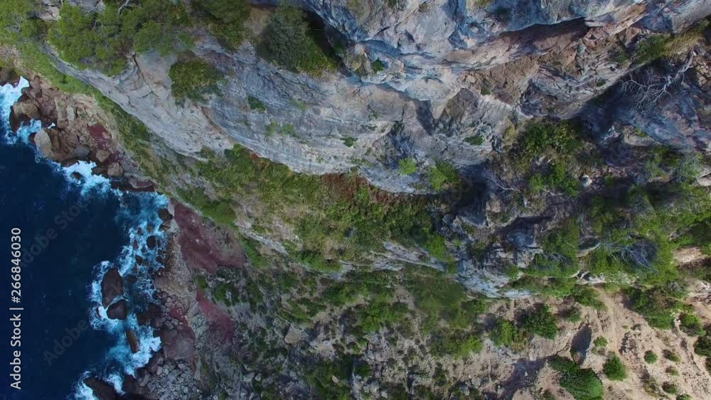 Rock cliff by the ocean aerial view. Rock tower on a rock cliff by the ocean. Rock cliff by the ocean aerial view. Rock tower on a rock cliff by the ocean.