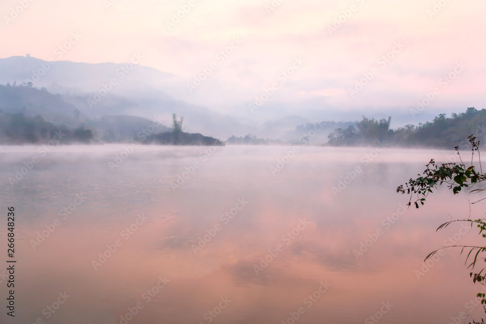 Tranquil Pa Khong Lake in the morning mist.