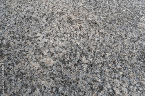 Granite crumb texture. Grey gritty rock surface. Non polished white granite as a background, texture for illustration