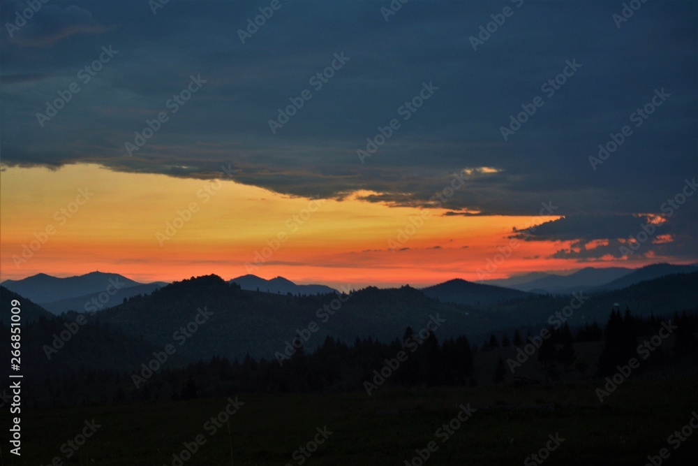 the silhouettes of the Carpathian mountains at sunset the silhouettes of the Carpathian mountains at sunset