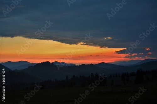 the silhouettes of the Carpathian mountains at sunset