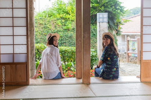 沖縄旅行　古民家で休む二人の女性 photo