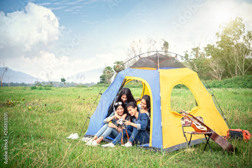 A group of girls that they are camping in the forest.
