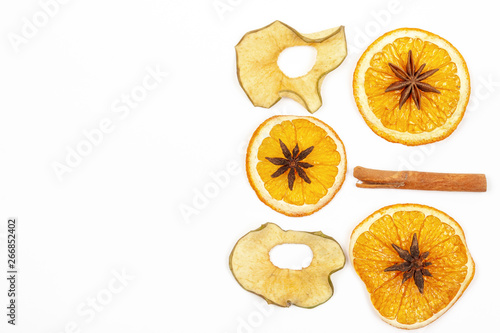 Dried lemon cinnamon star anise on a light background