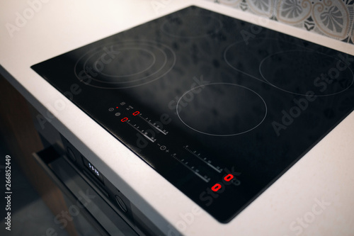 Fotografija New electric stove with induction cooktop in kitchen, closeup
